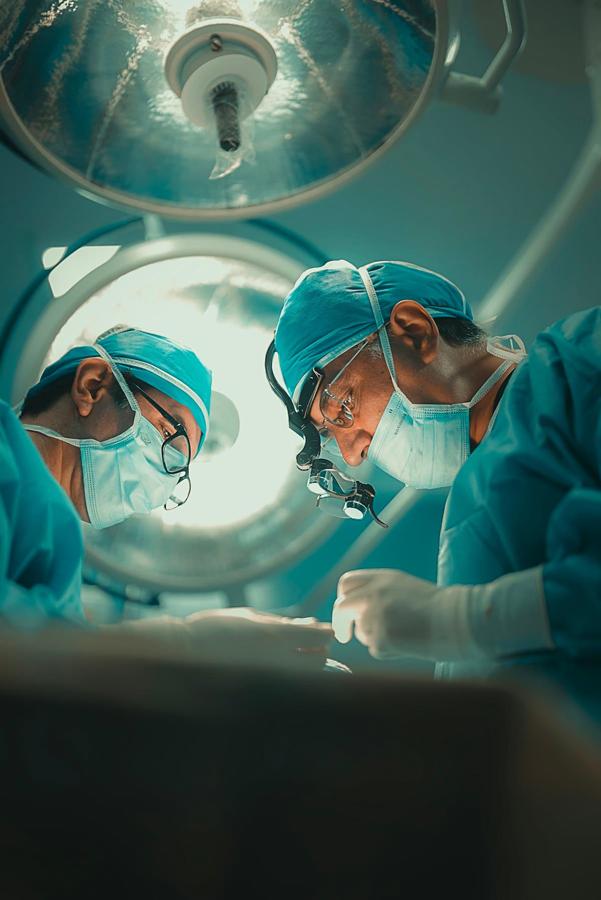 Surgeons working under the operating lights