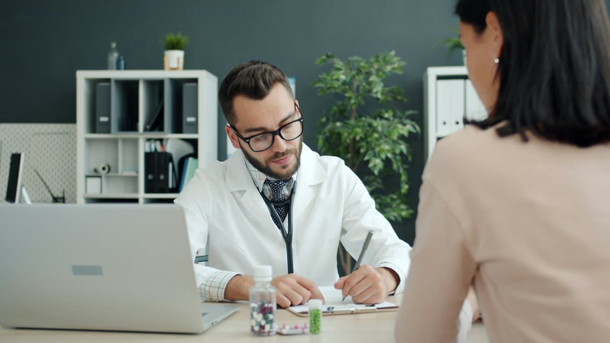 Physician talking a patient through her procedure